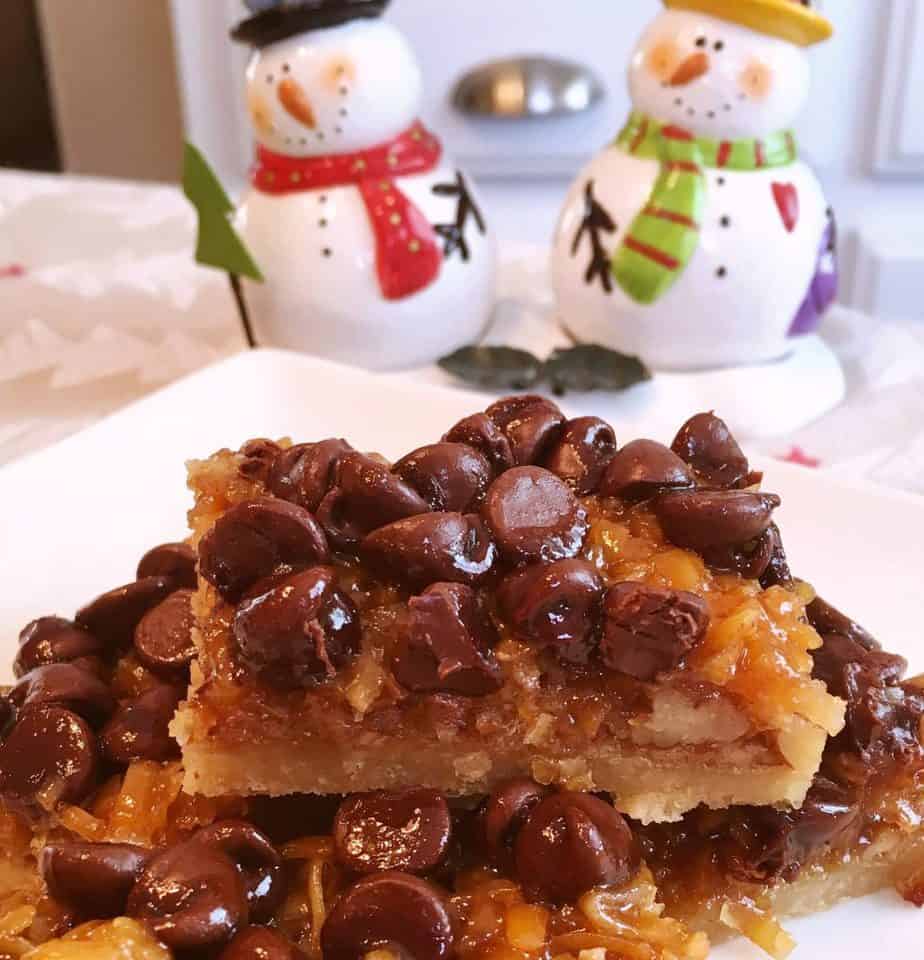 Easy Chocolate Caramel-Pecan Bars stacked on a plate.