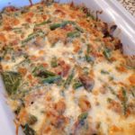Green Bean Casserole in the dish with browned cheese on top.