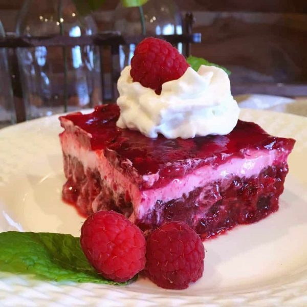 Cut slice of Raspberry Layered Jello Salad