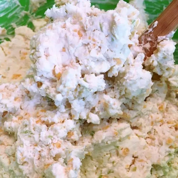 cheese ball ingredients being mixed together 