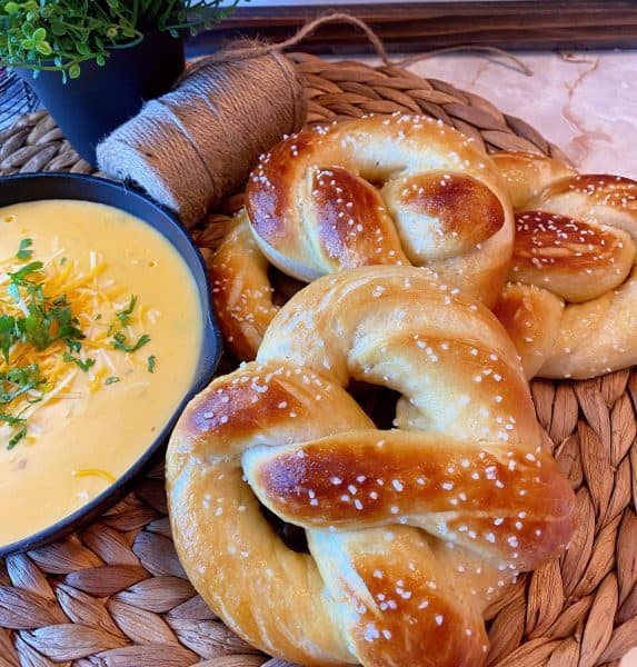 Homemade soft pretzels with cheese sauce 