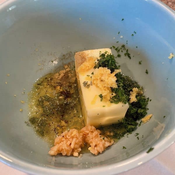 butter and herbs in bowl for lemon garlic butter 