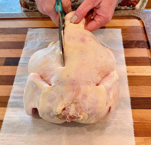 Cutting the back bone out of the chicken