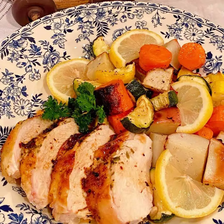 Spatchcock Chicken and roasted veggies on a plate.