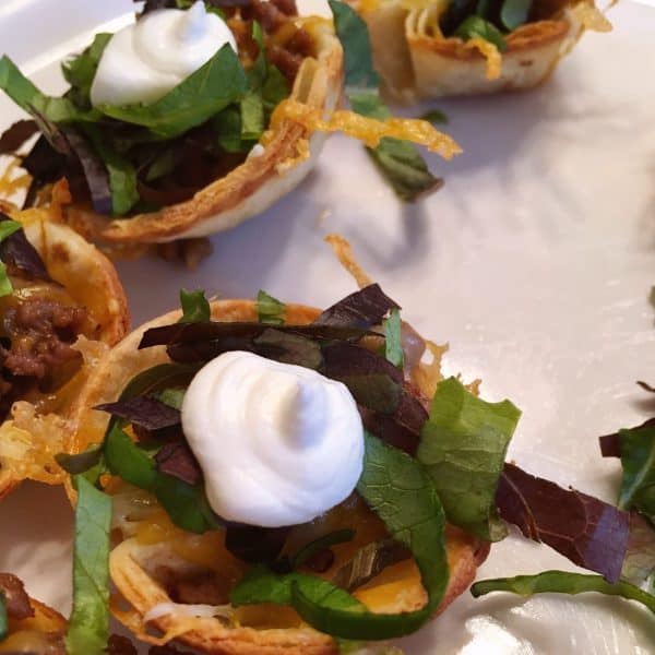 Tostada Cups filled with lettuce and sour cream