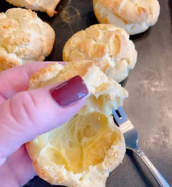 Removing the tops from cream puffs
