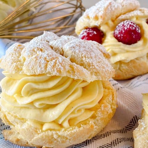 Close-Up Photo of a Cream Puff with powder sugar.