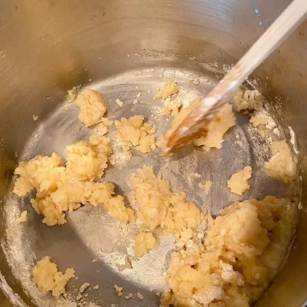 Stirring in the flour and salt to create pastry dough