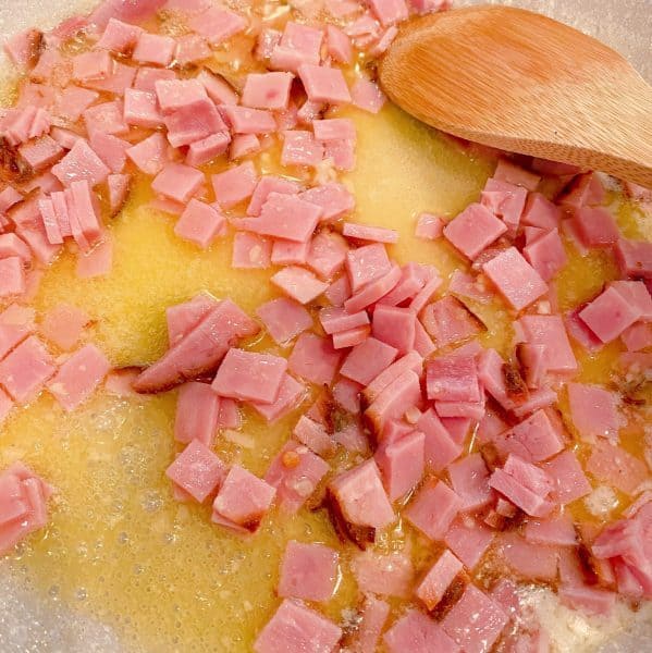 sauteing the garlic and ham in skillet over medium heat