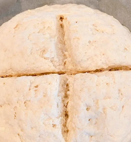 cutting an "x" into the top of the dough