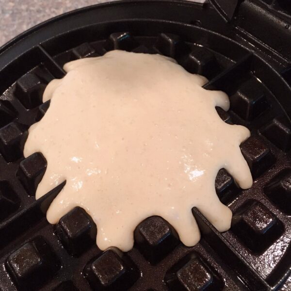 poured waffle batter in waffle iron.