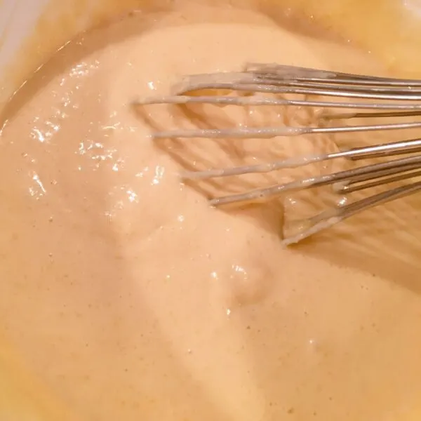 whisking dry ingredients into wet ingredients