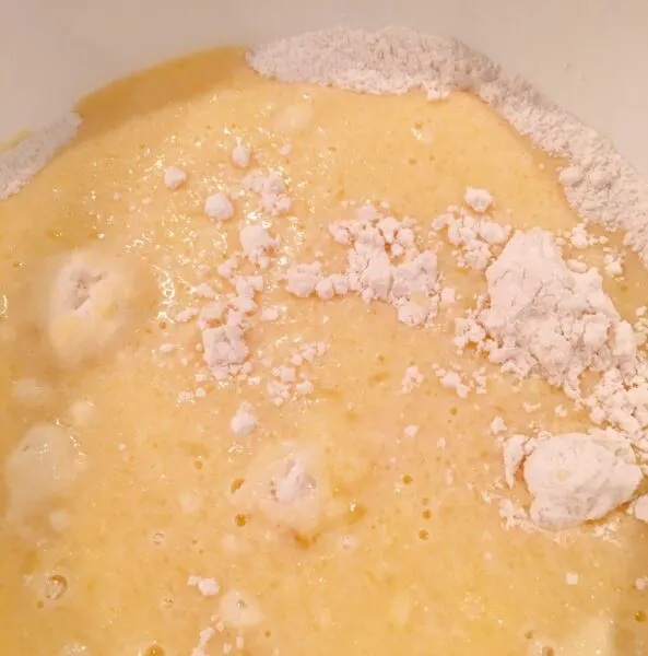 poured milk into center of well in flour mixture