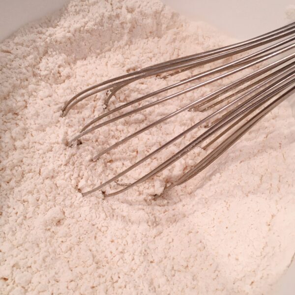 Whisking flour and other dry ingredients in a bowl