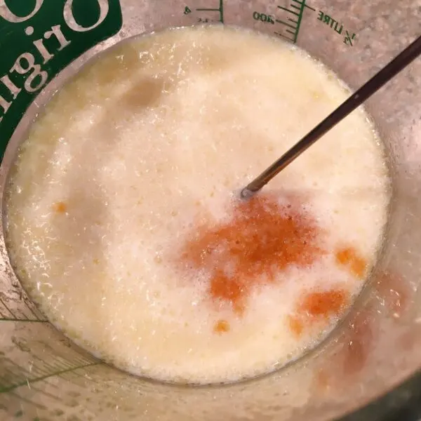 whisking milk into butter and adding vanilla