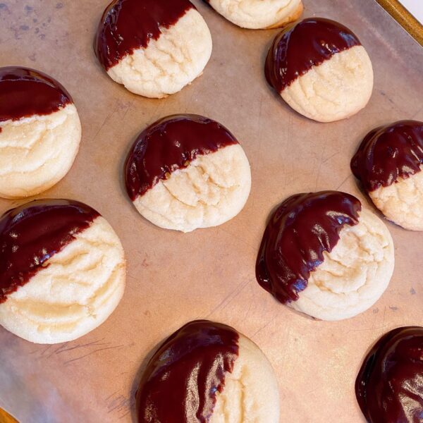 dipped cookies on a baking sheet