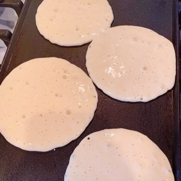 pancake batter on hot griddle.