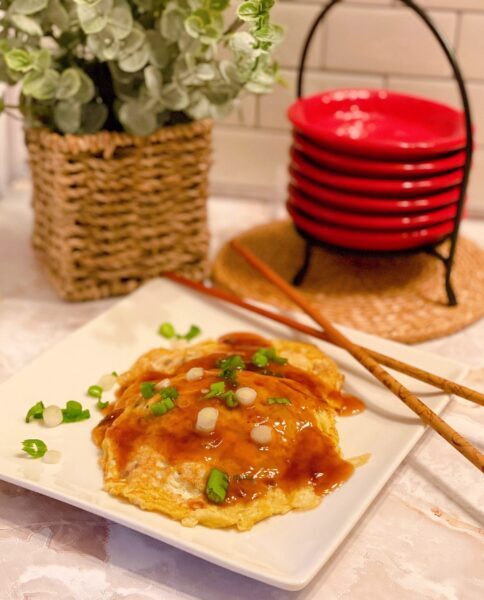Egg Foo Yung on a plate with gravy