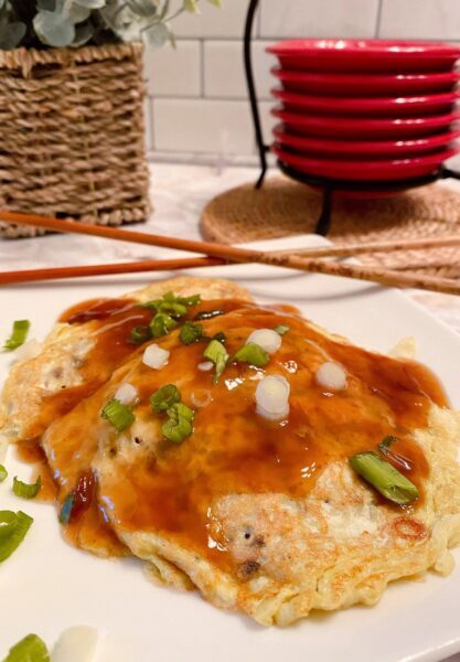 Egg Foo Yung on a plate with gravy