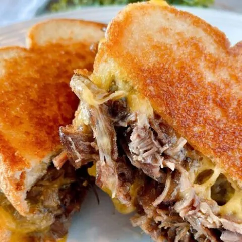 Roast beef grilled cheese sandwich cut in half and ready to eat