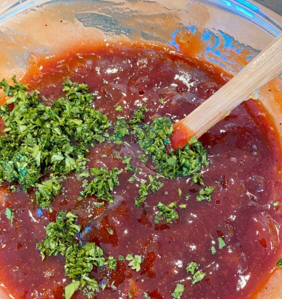 Adding Cilantro to sauce.