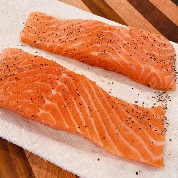 Salmon Fillets rinsed and on a paper towel seasoned with salt and pepper.