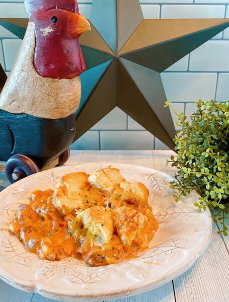 Dinner plate filled with Cowboy Casserole on kitchen counter.