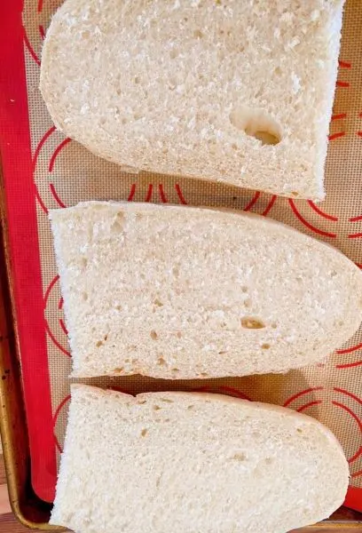 French Bread sliced in half on a baking sheet