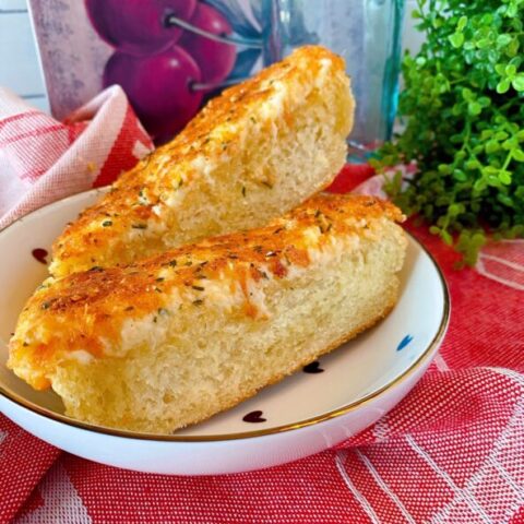 Slices of Cheesy Garlic Bread on a plate