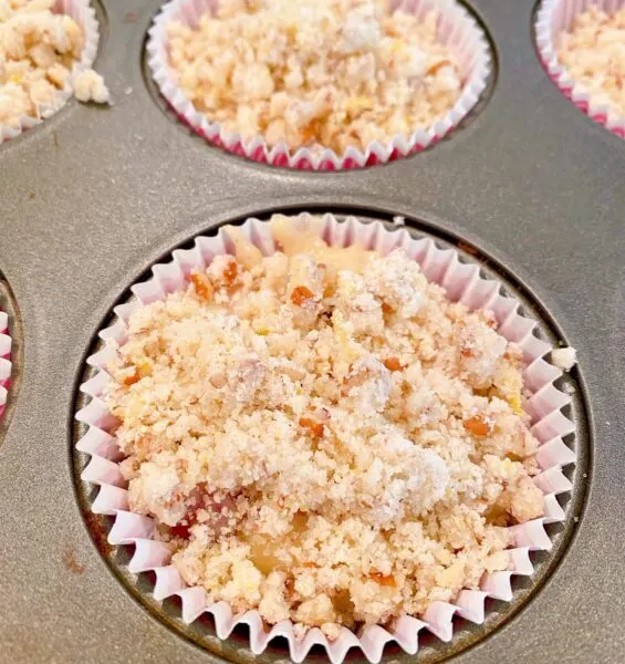 Muffins topped with crumble streusel topping.