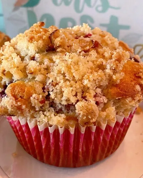 close up photo of one of the streusel topped mixed berry muffin.
