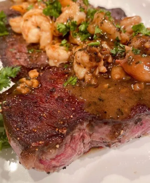 Wine sauce poured over the top of steaks and shrimp.