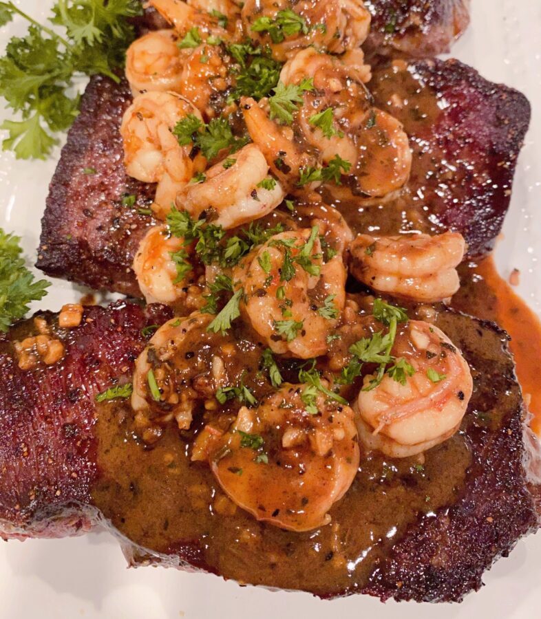 Denver Steaks on a plate with shrimp and sauce