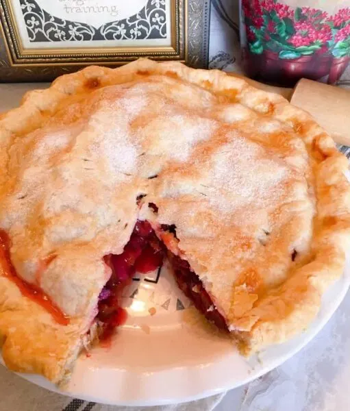 Plum Pie with a slice cut out of the pie.