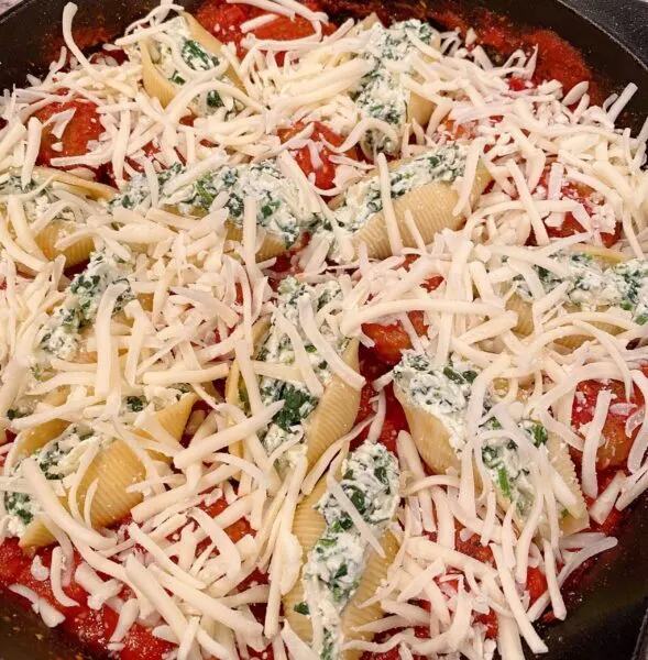 Top the shells and meatballs with remaining pasta sauce and cheese.