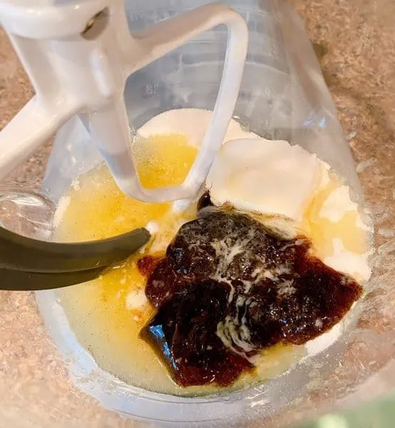 Sugar, melted butter, and vanilla bean paste in bowl of mixer.