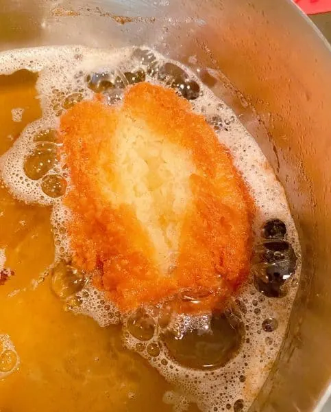 Donut frying in hot oil.