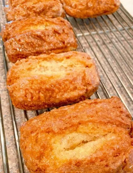 Buttermilk bars on a cooling rack after being dipped in vanilla bean glaze.