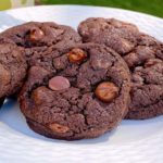 Chocolate Chocolate Chip Cookies on a white plate.