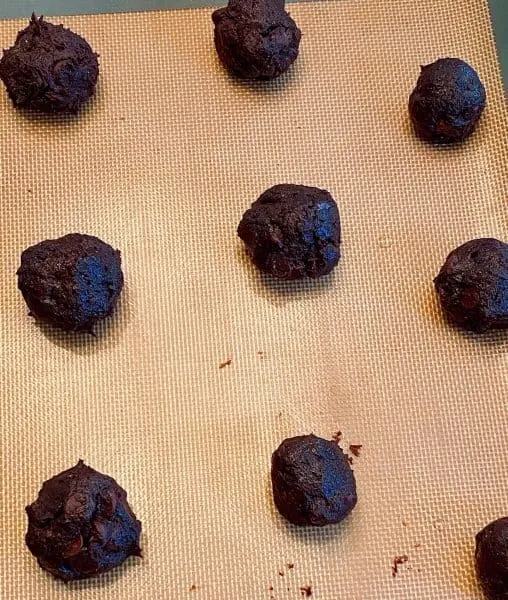 Chocolate Cookie Dough rolled into balls on a baking sheet.