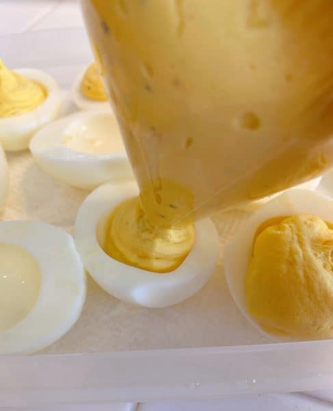 Filling the egg whites with the yolk mixture. 