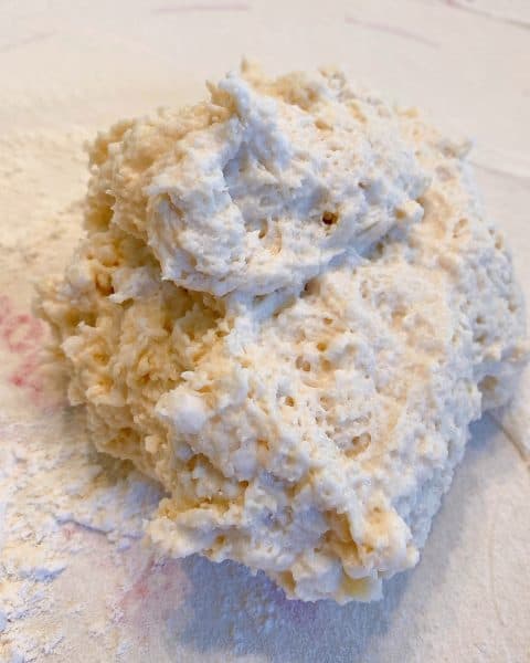 Biscuit dough on floured surface ready to knead.