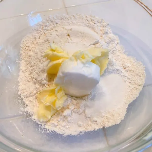 Bowl with butter and shortening and dry ingredients for biscuits.