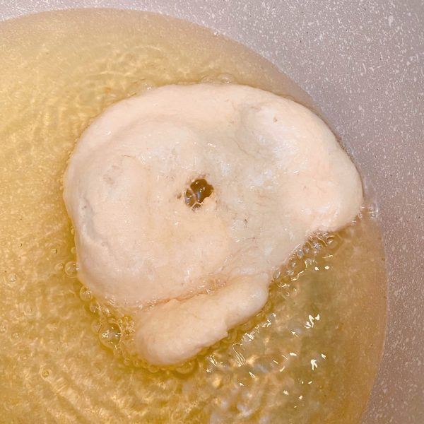 Frying the Indian Fry Dough in a large pot with hot oil.