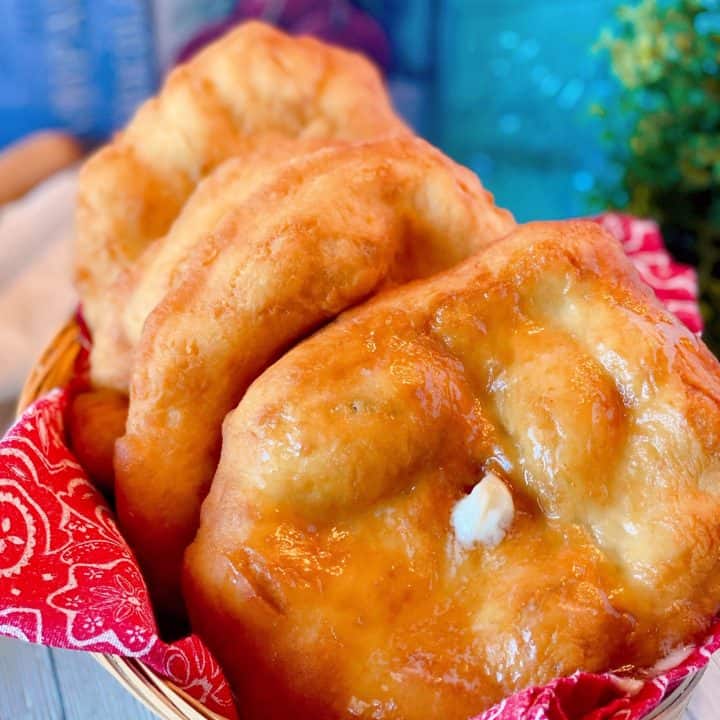 Basket full of Indian Fry bread with butter and honey.