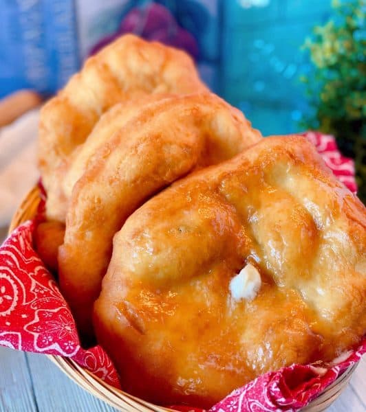 Basket full of Indian Fry bread with butter and honey.