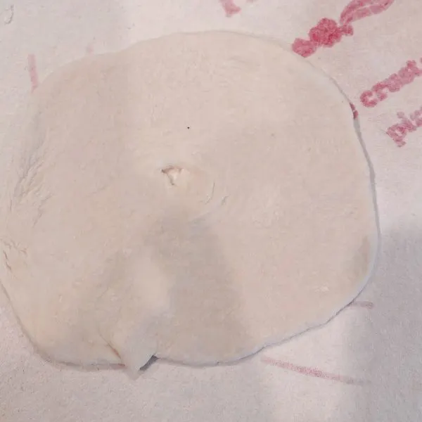 Indian Fry Bread dough rolled into a disc with a hole in the center.