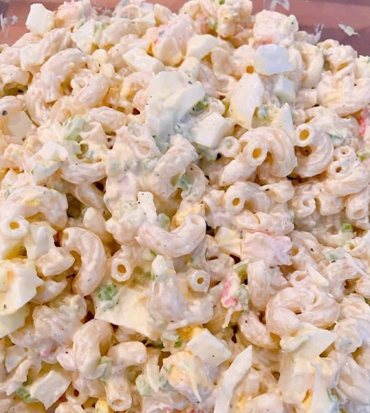 Seafood Macaroni Salad mixed in a bowl and ready to chill in the refrigerator.