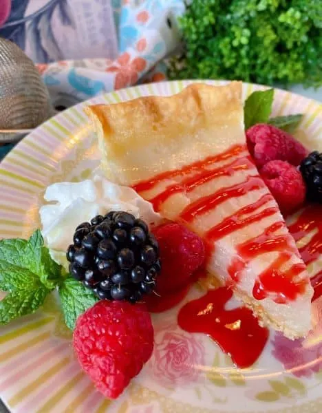Slice of Depression Water Pie with berries and raspberry sauce. 