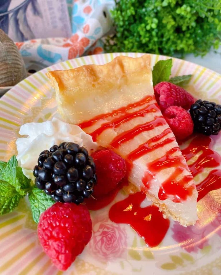 Slice of Water Depression Pie with Fresh berries and raspberry sauce